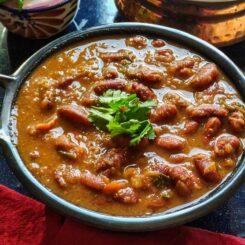 Rajma masala garnished with coriander leaves served in a black wok