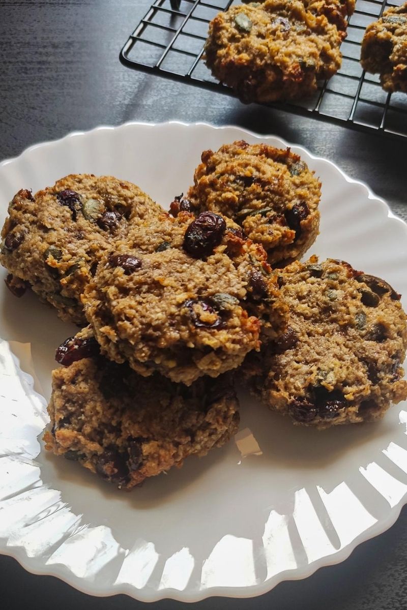 Vegan breakfast cookies on a white plate more cookies in the background