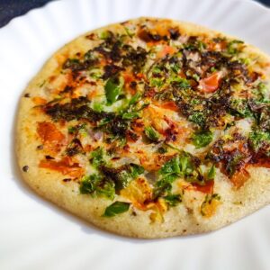 Rava Uttapam served on a white plate