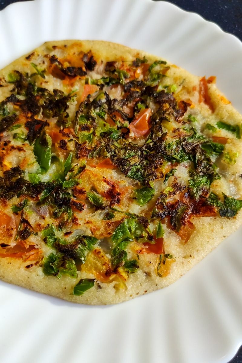 Rava Uttapam served on a white plate