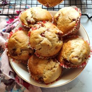 Vegan strawberry muffins served in a white bowl kept on a pink table napkin