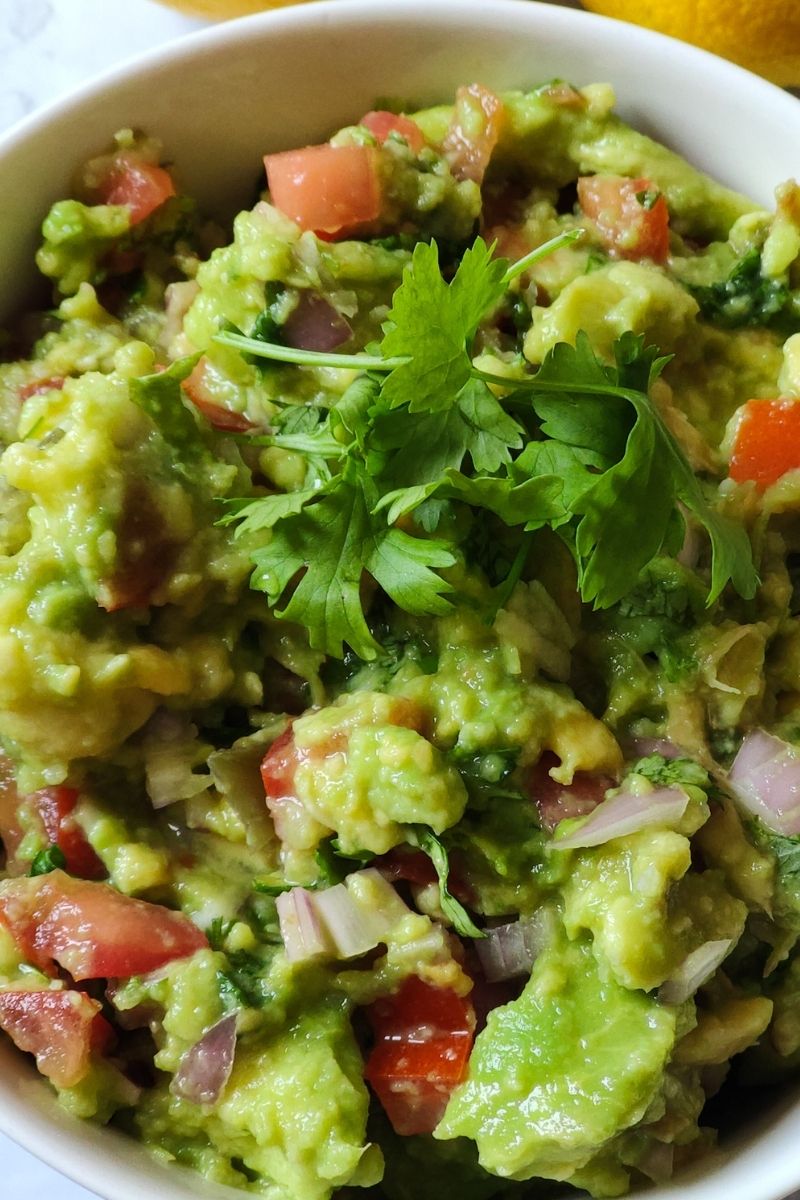 guacamole garnished with fresh coriander leaves