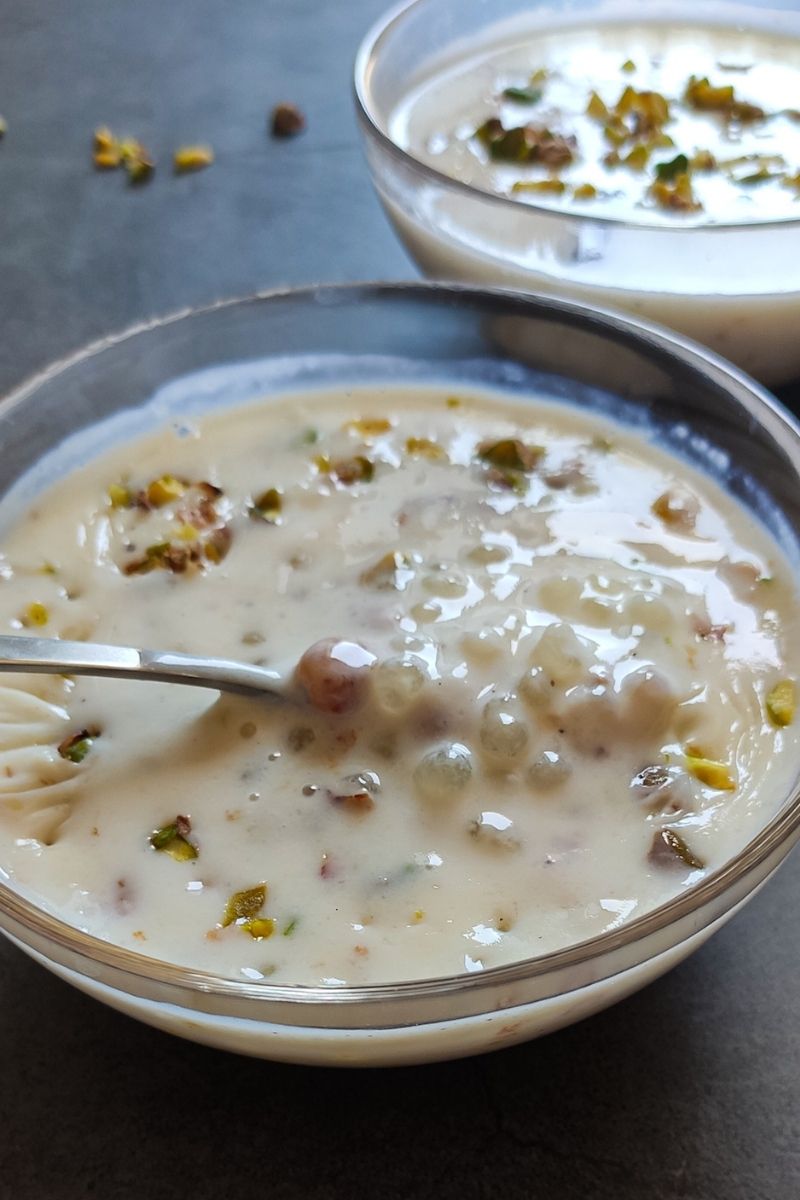 Sabudana kheer in a glass bowl with another bowl in the background