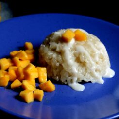 Thai mango sticky rice served on a blue plate