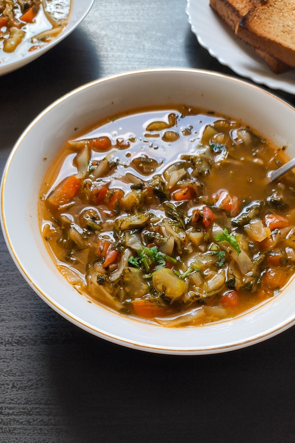 vegetarian cabbage soup served in a white bowl
