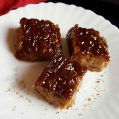 Three pieces of biko served on a white plate