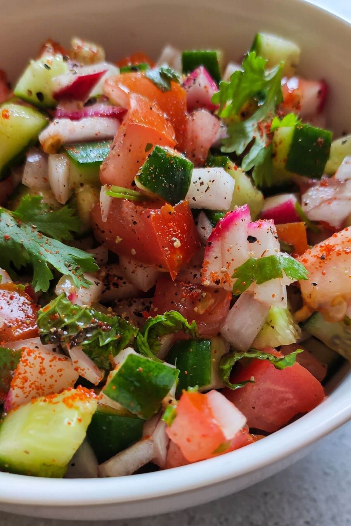 Spicy kachumber salad in a white bowl