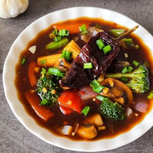 vegetables in hot garlic sauce served in a white bowl.
