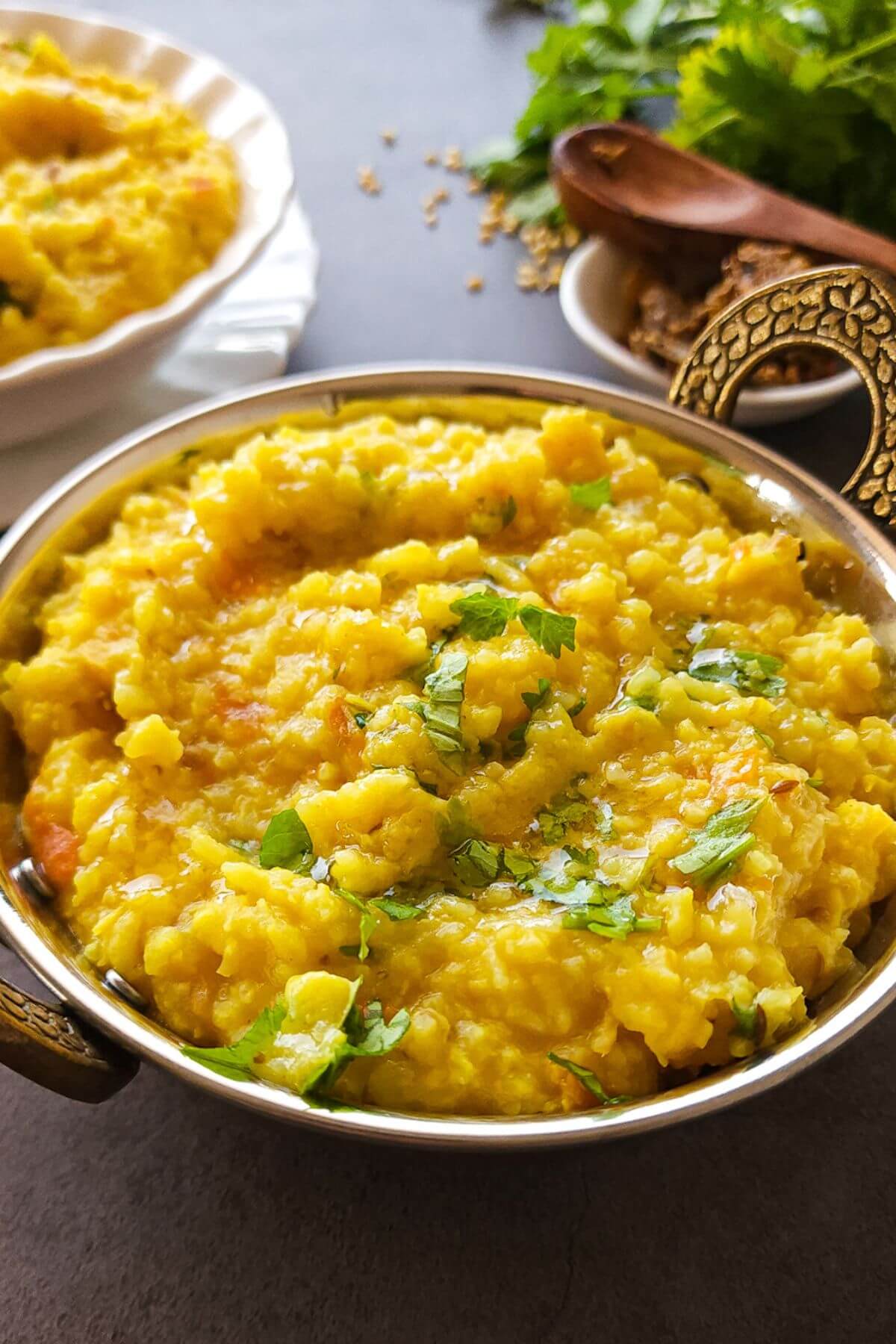 Moong dal Khichdi garnished with chopped cilantro in a small wok.