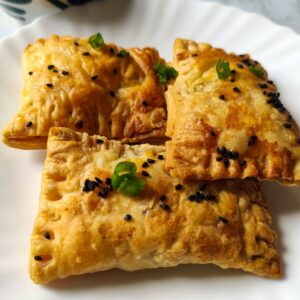 Three vegetable puffs served on a white plate