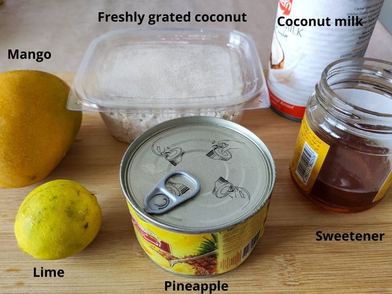 Ingredients of tropical popsicle kept on a chopping board