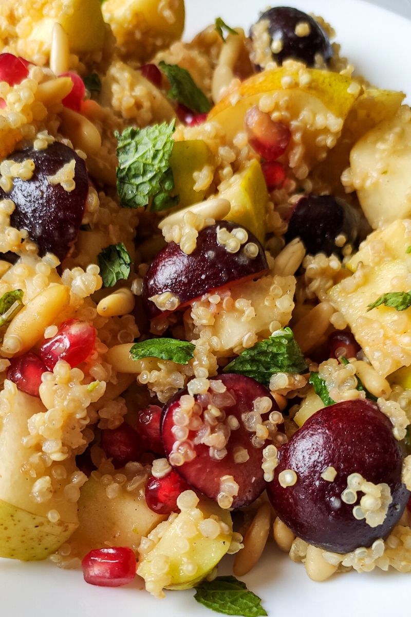 Close up shot of quinoa salad with fruits and nuts