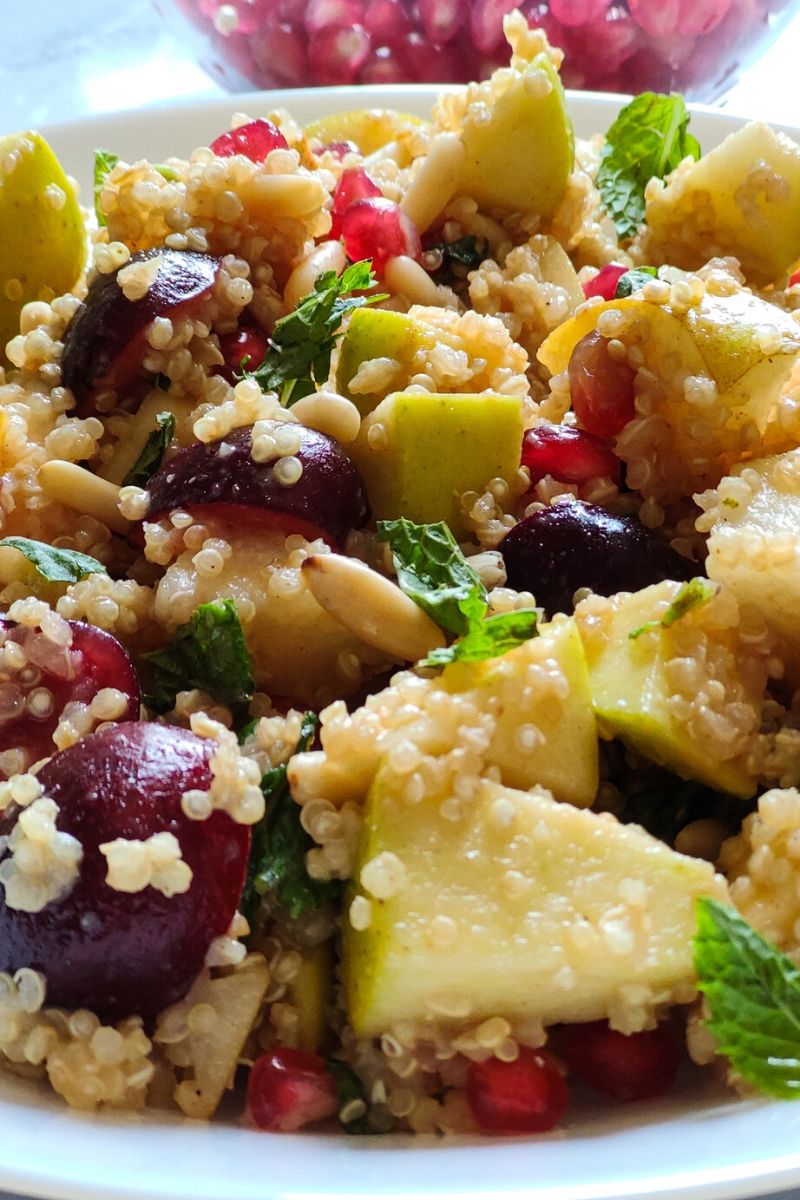 Close up shot of quinoa salad with fruits and nuts