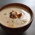 roasted cauliflower soup served in a wooden bowl