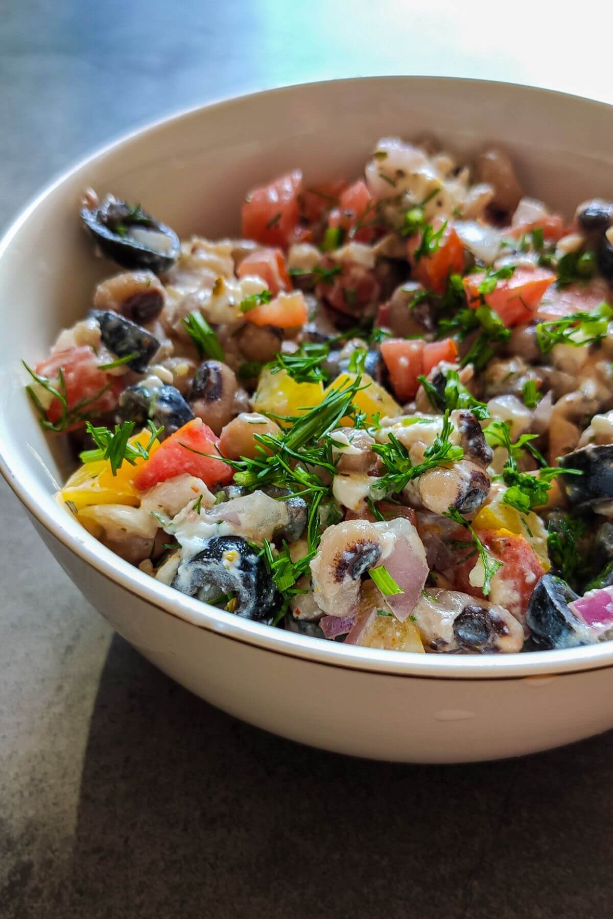 Black eyed peas and feta salad in a white bowl