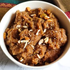 Singhare ka halwa garnished with chopped nuts served in a white bowl