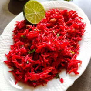 Beetroot rice garnished with a slime slice served on a white plate