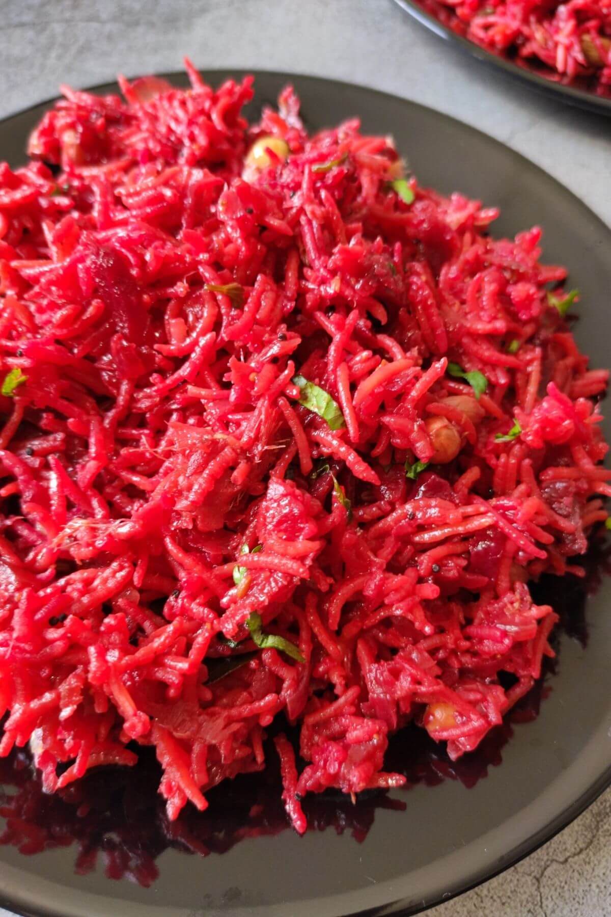 Beetroot rice served on a black plate