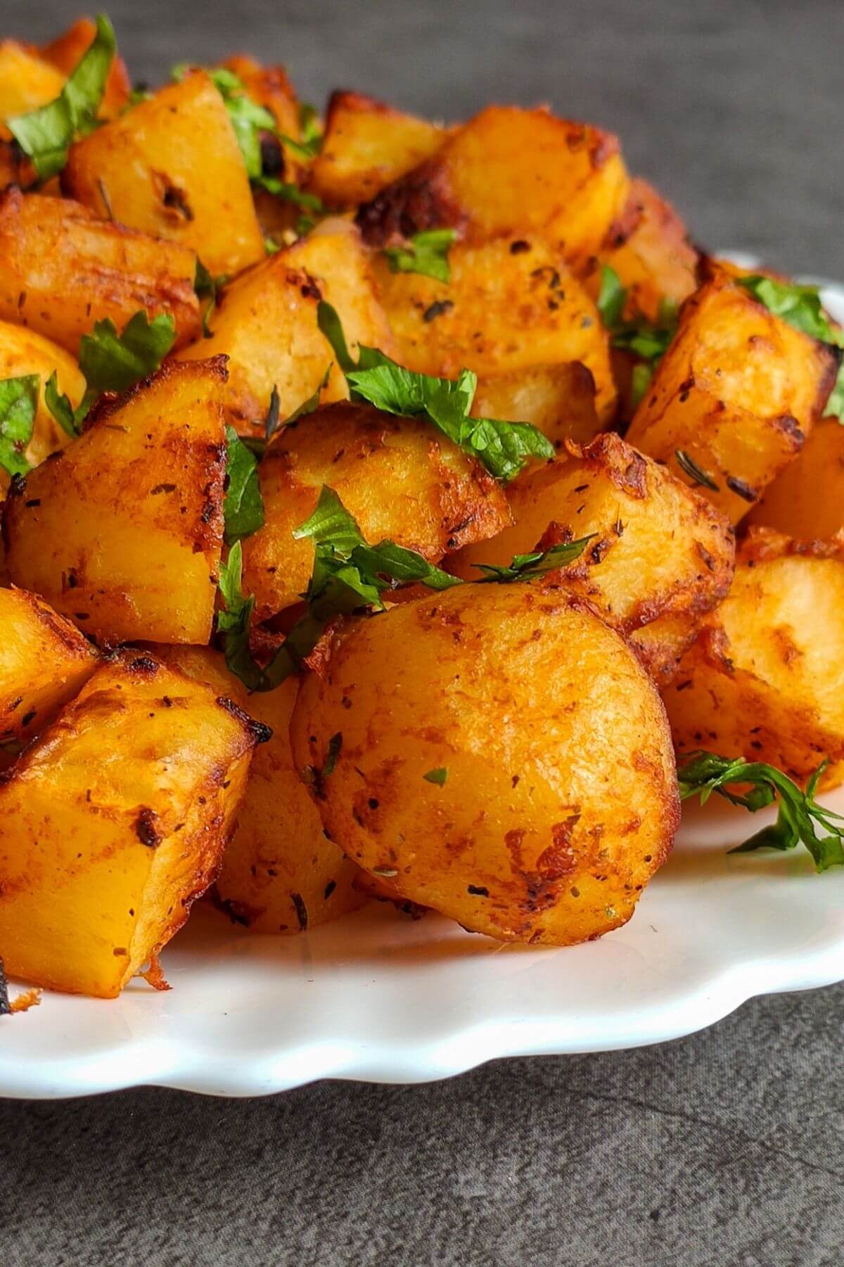 Roasted Spanish potatoes served on a white plate
