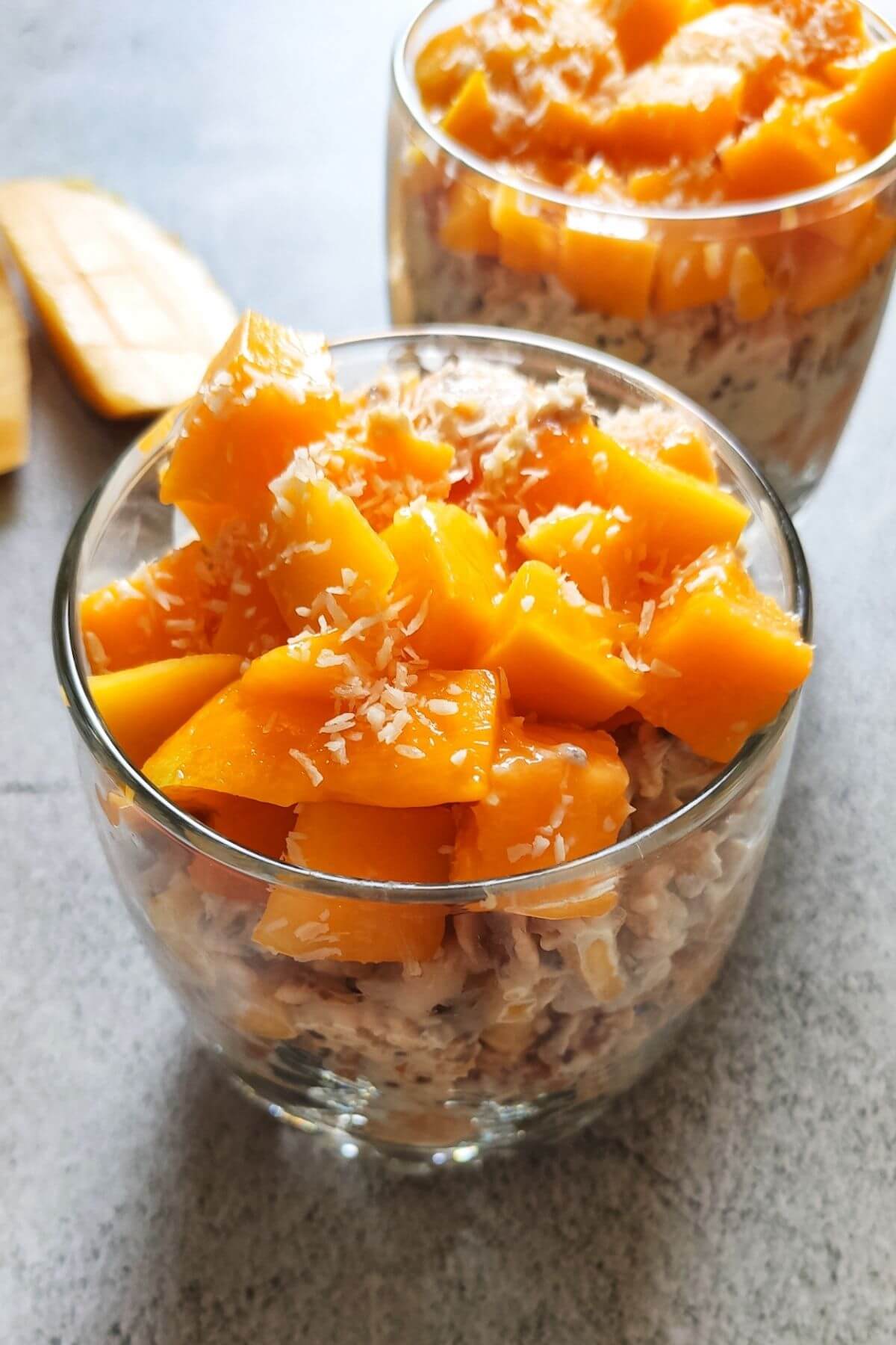 Mango coconut overnight oats in a glass bowl