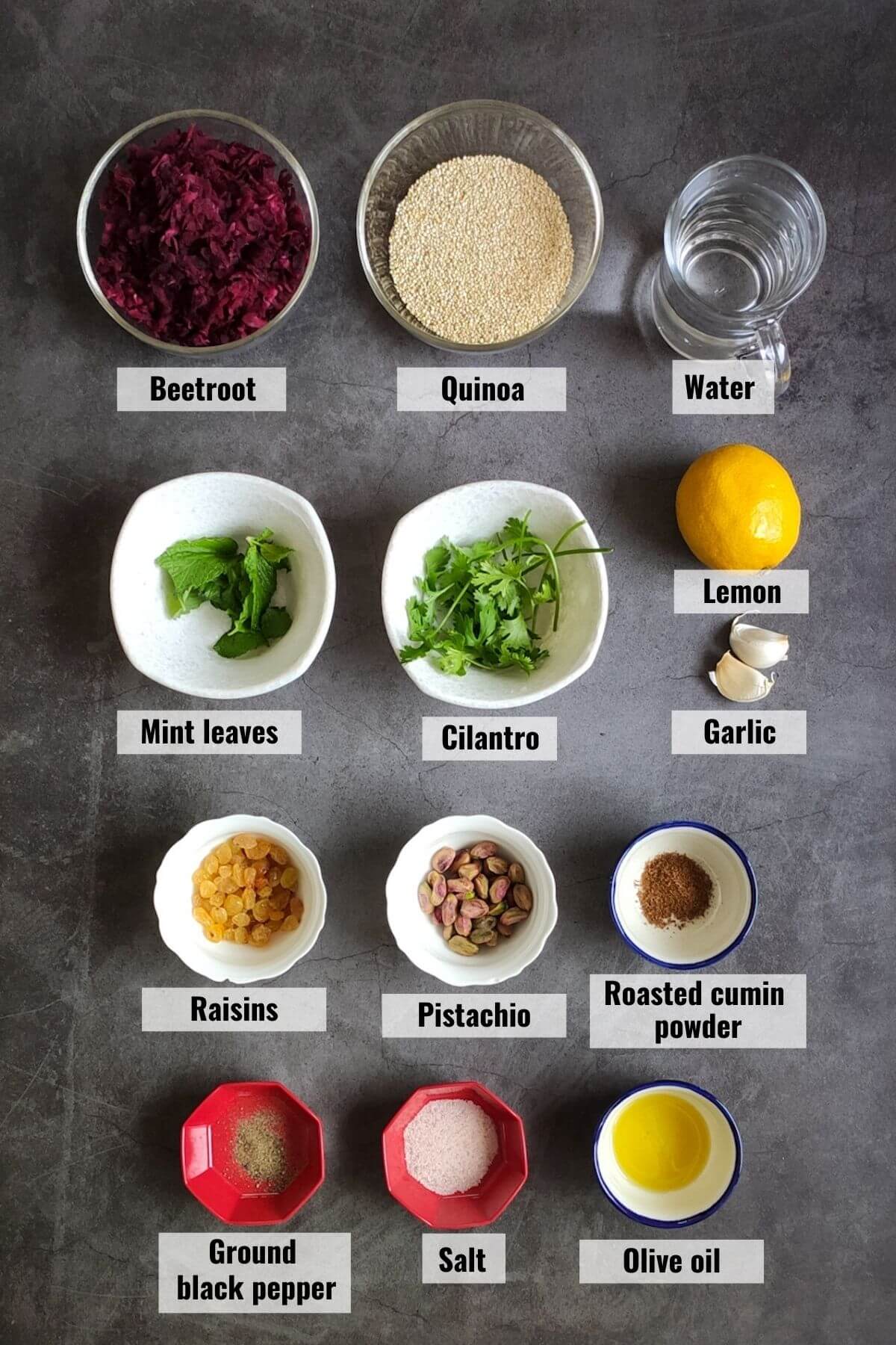 Ingredients required to make quinoa beet salad served on a grey surface