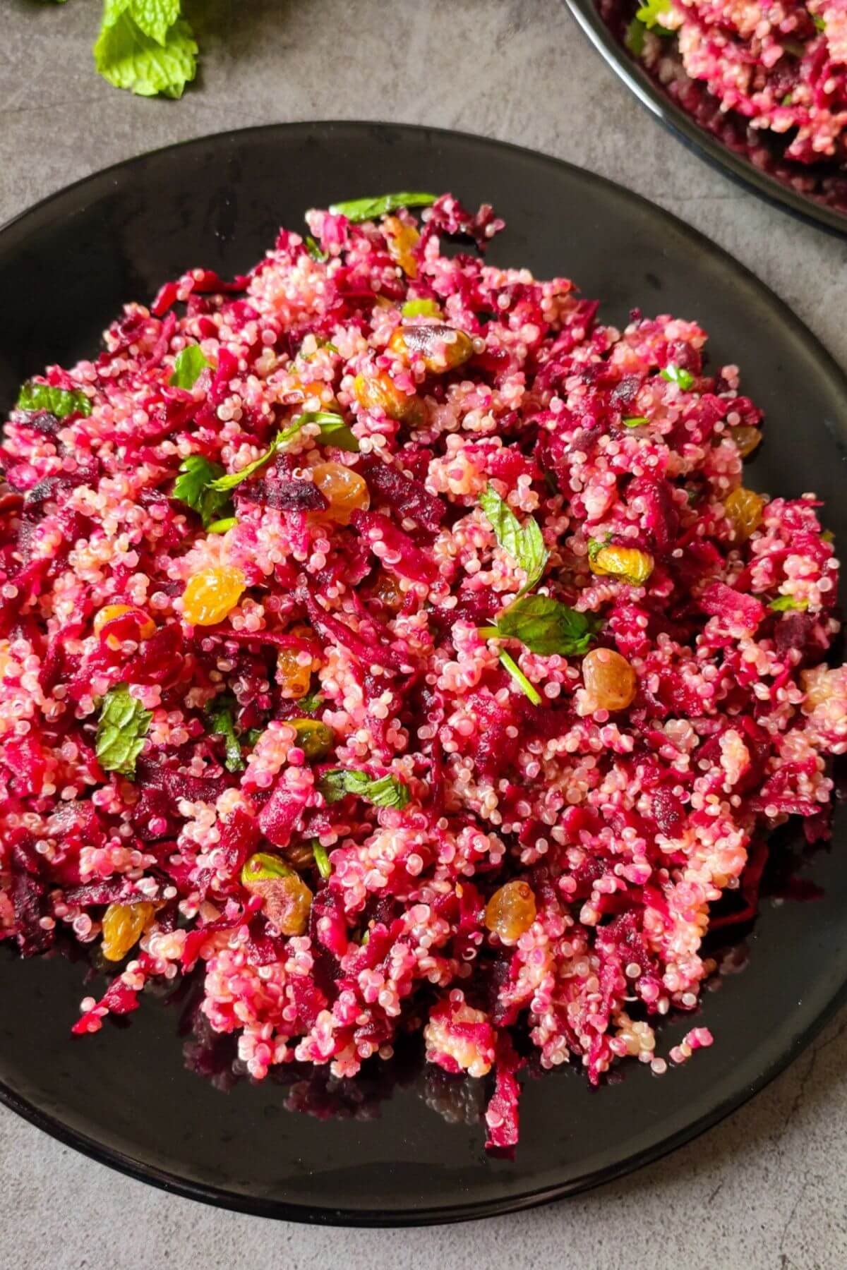 Beetroot quinoa salad served on a black plate