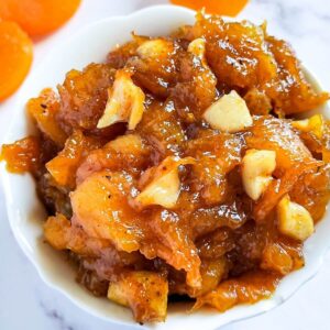 apricot chutney in a bowl with dried apricots in the background.