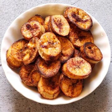 Baked plantain in a white bowl.
