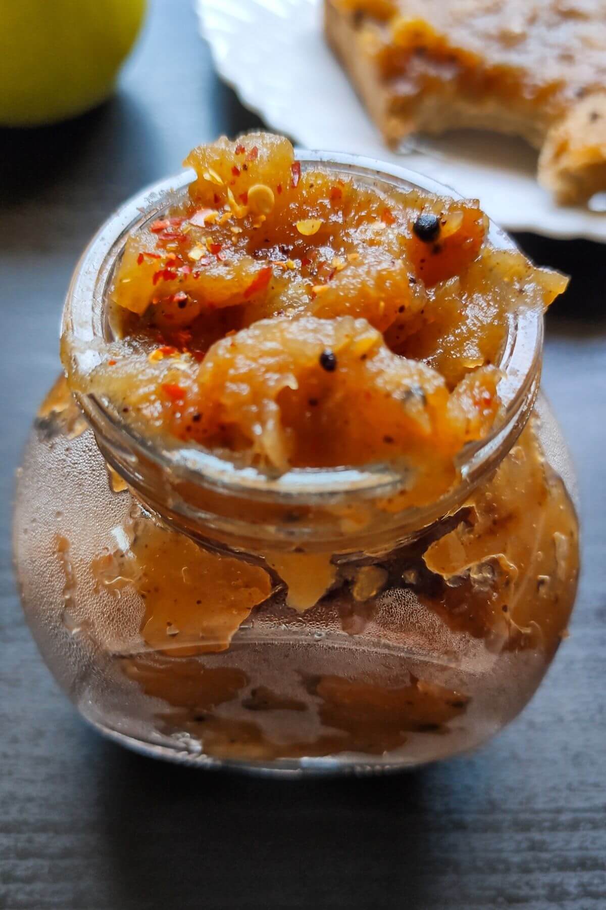 Indian apple chutney in a small glass jar.