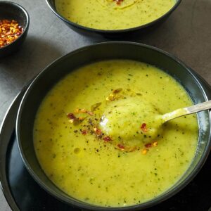 Two bowls of roasted zucchini and potato soup.