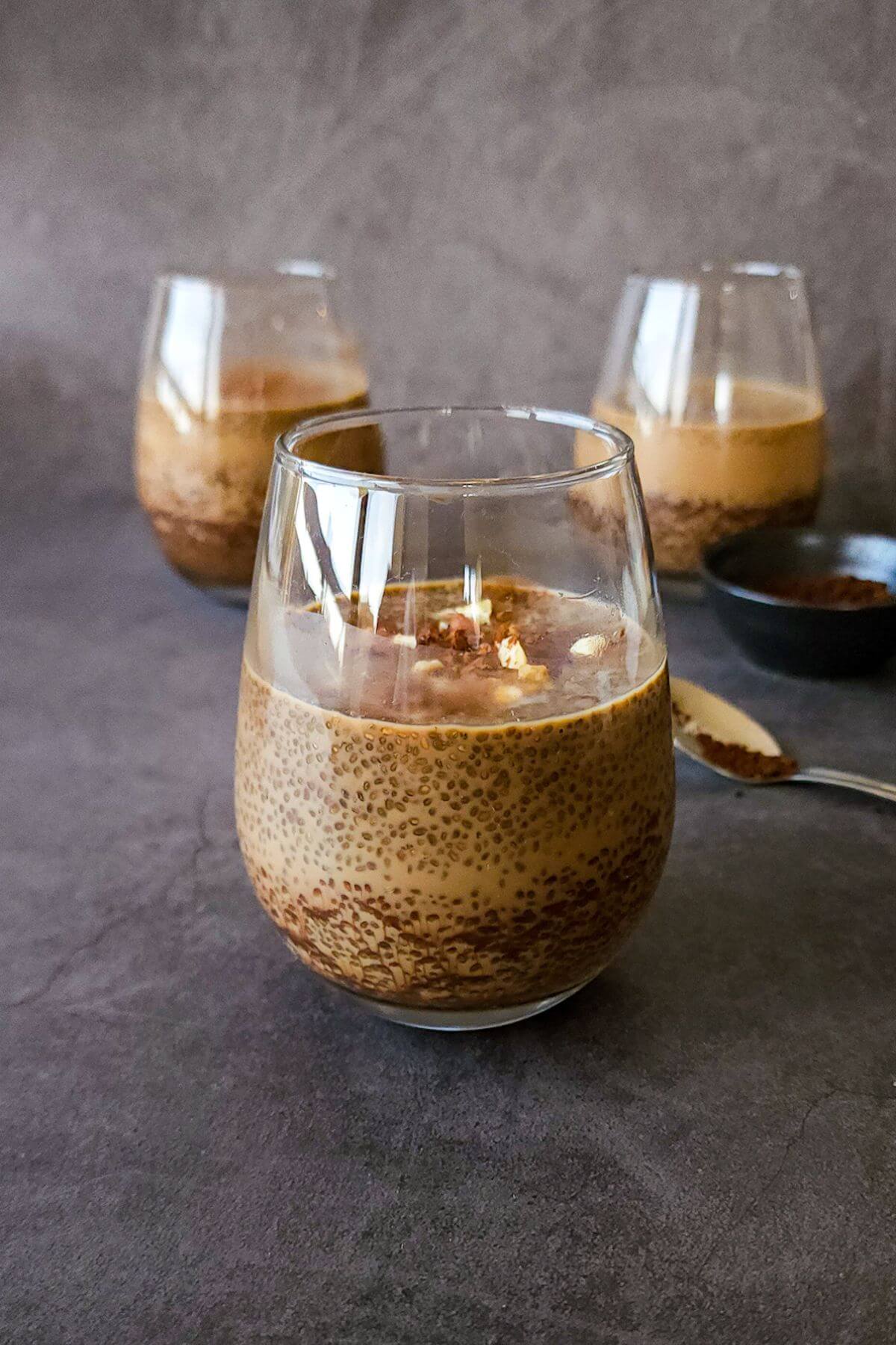 Three glasses of chia pudding with coffee.