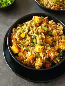 Easy paneer fried rice in a black bowl.
