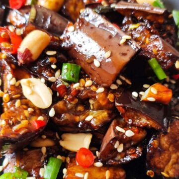 Chinese eggplant with garlic sauce topped with peanuts, sesame seeds, and chopped scallions.