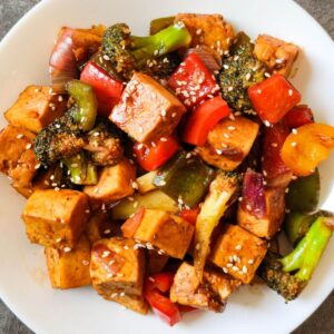 Sweet and sour tofu served on a white plate.