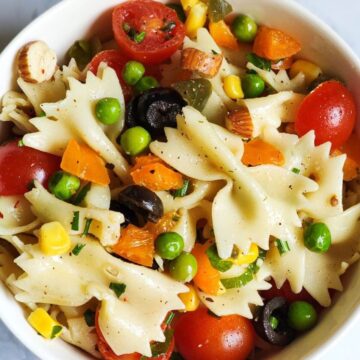 Pasta salad with vegetables in a white bowl