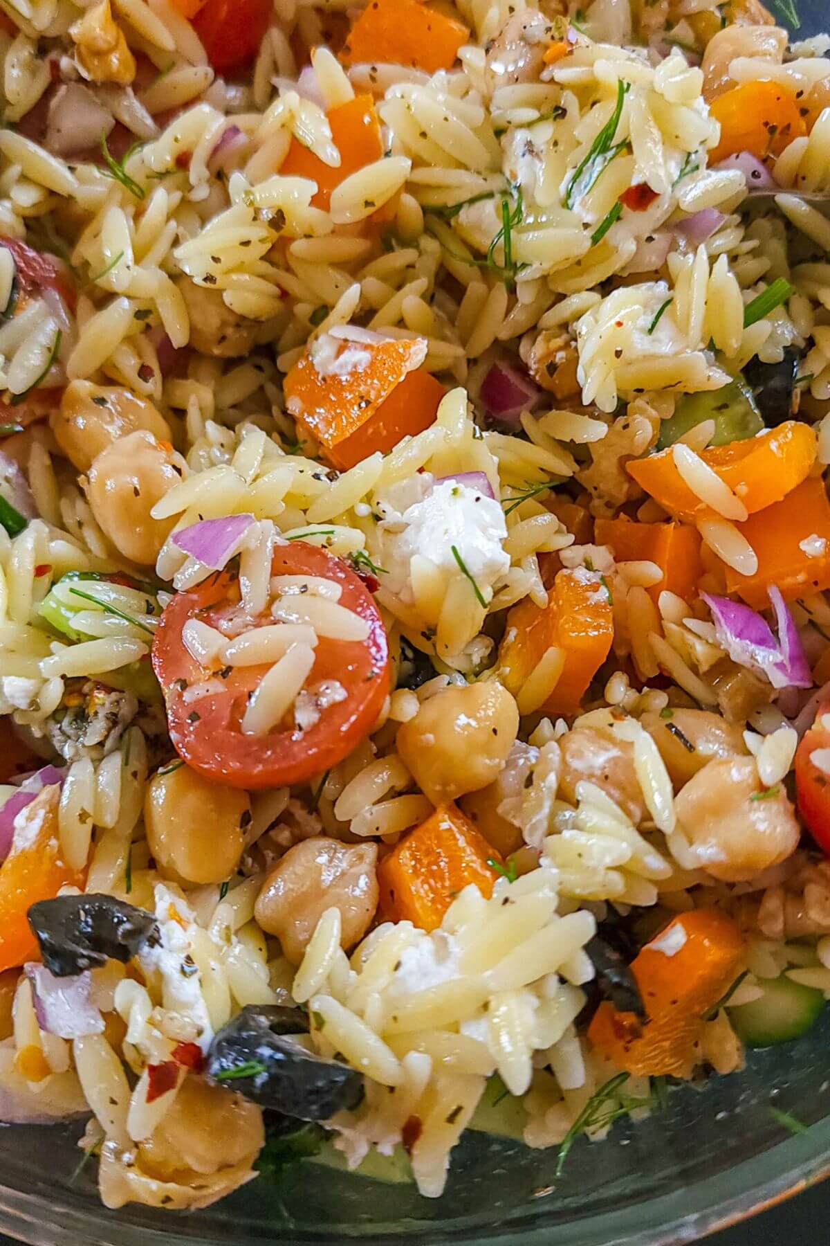 Close up shot of Mediterranean orzo salad with chickpeas and feta.