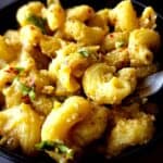 Pumpkin ricotta pasta in a bowl with a fork.