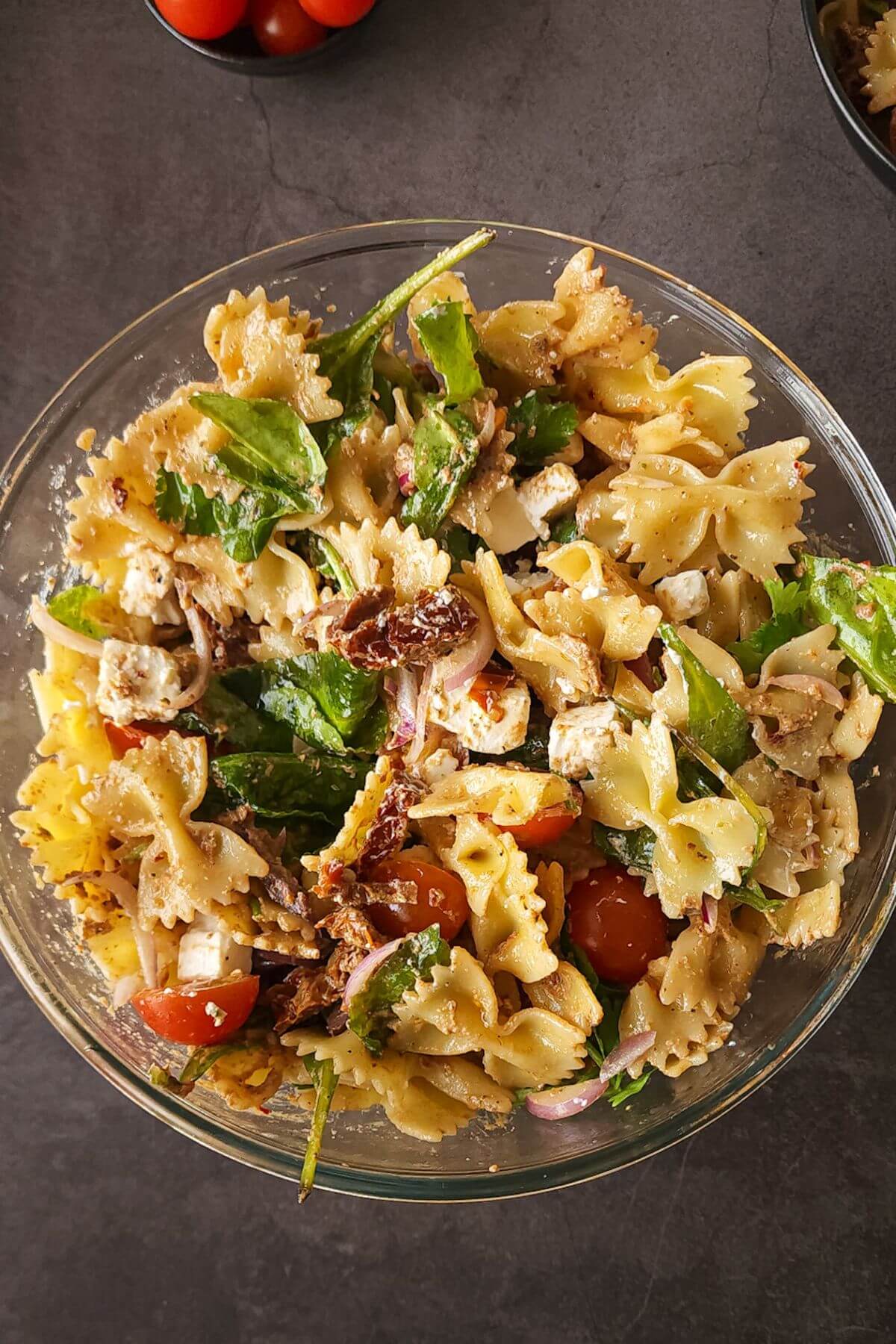 Greek pasta salad with sundried tomatoes and feta in a bowl.