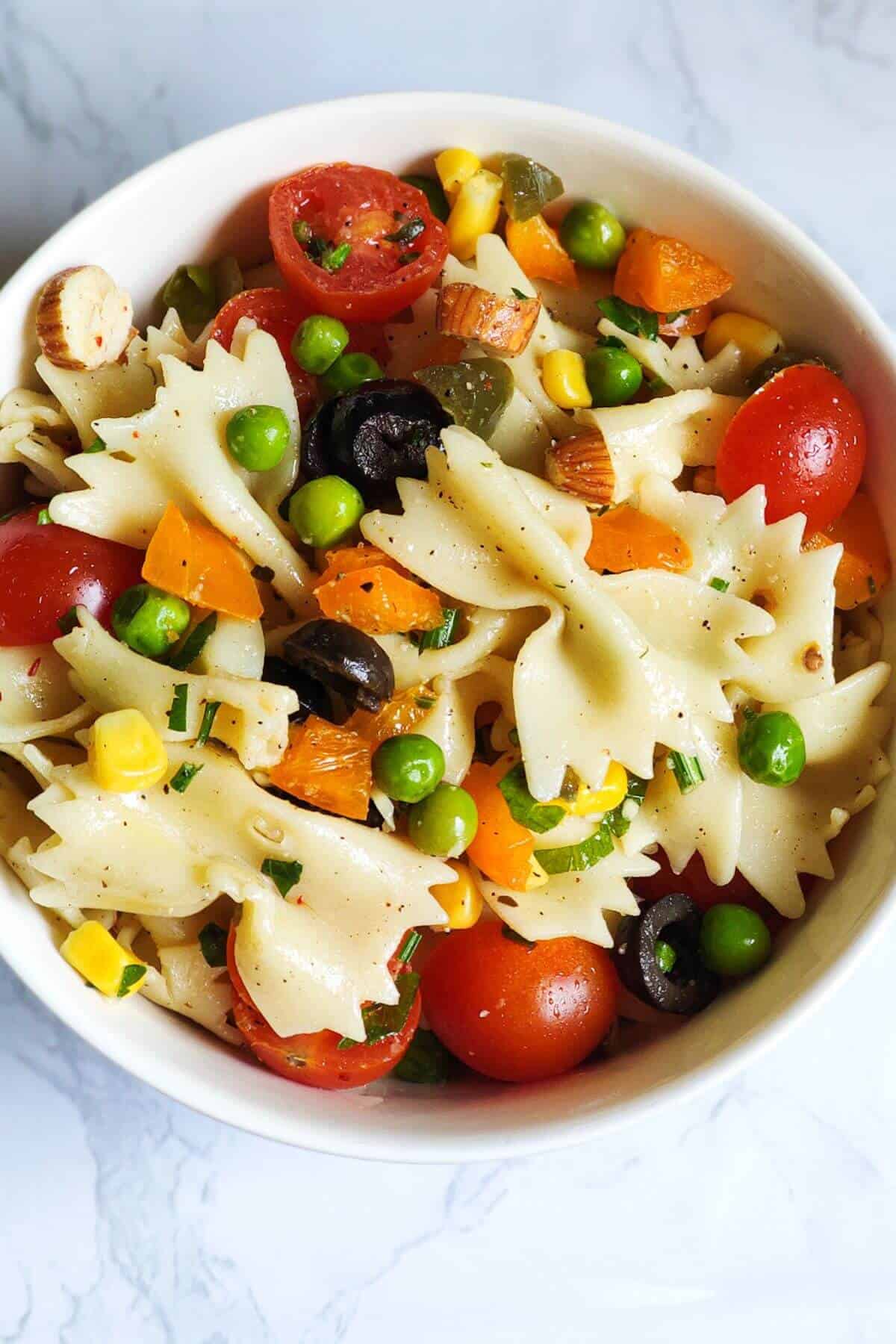 Vegetable pasta salad served in a white bowl.