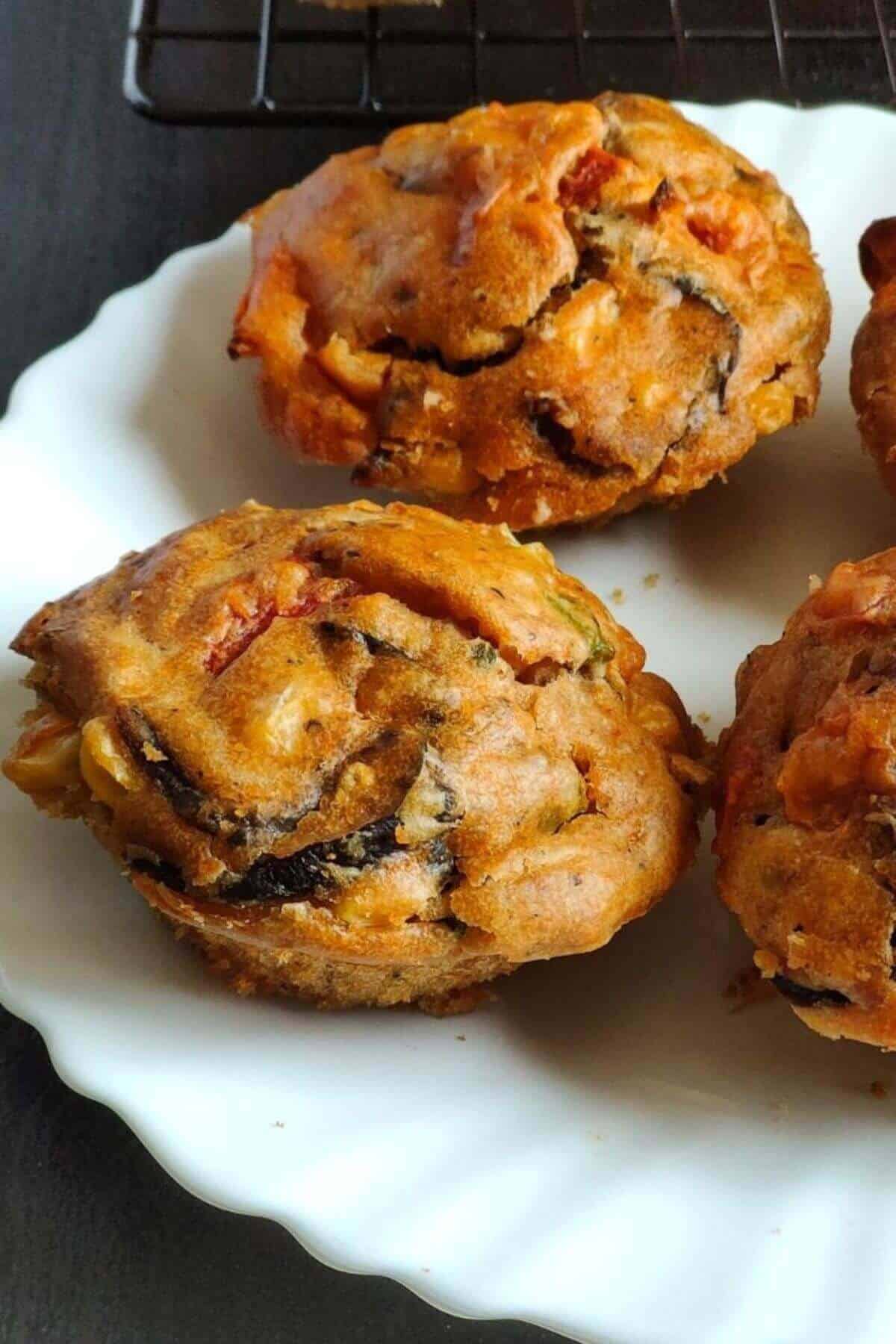 Vegan savoury muffins served on a white plate.