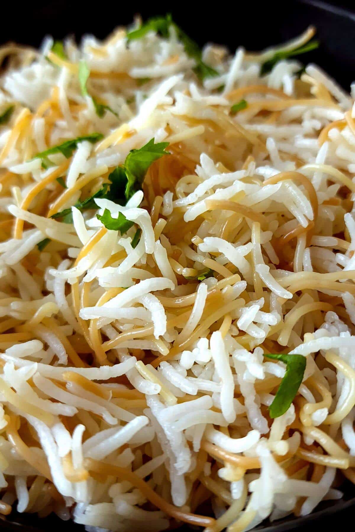 Close up shot of Lebanese rice with vermicelli garnished with chopped parsley.