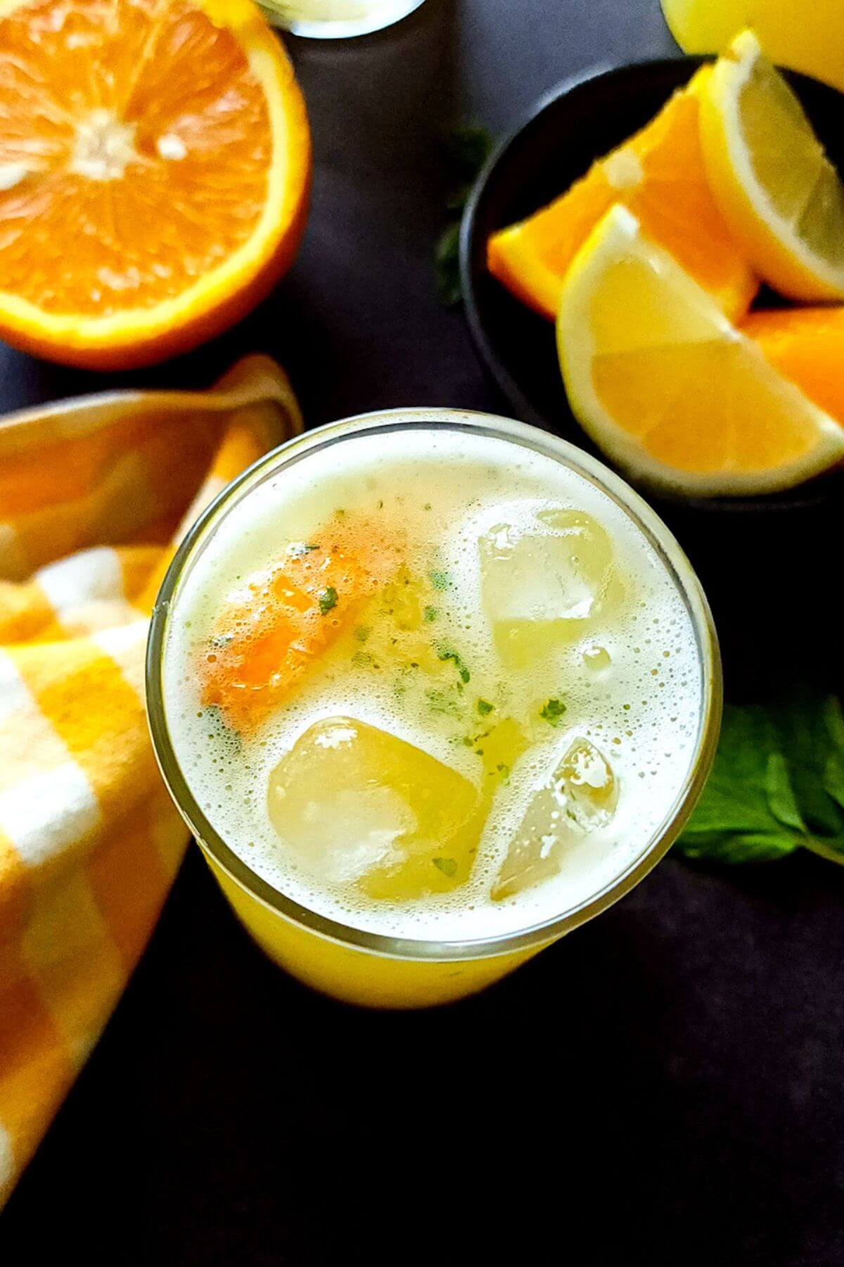Orange lemonade in a glass with ice cubes.