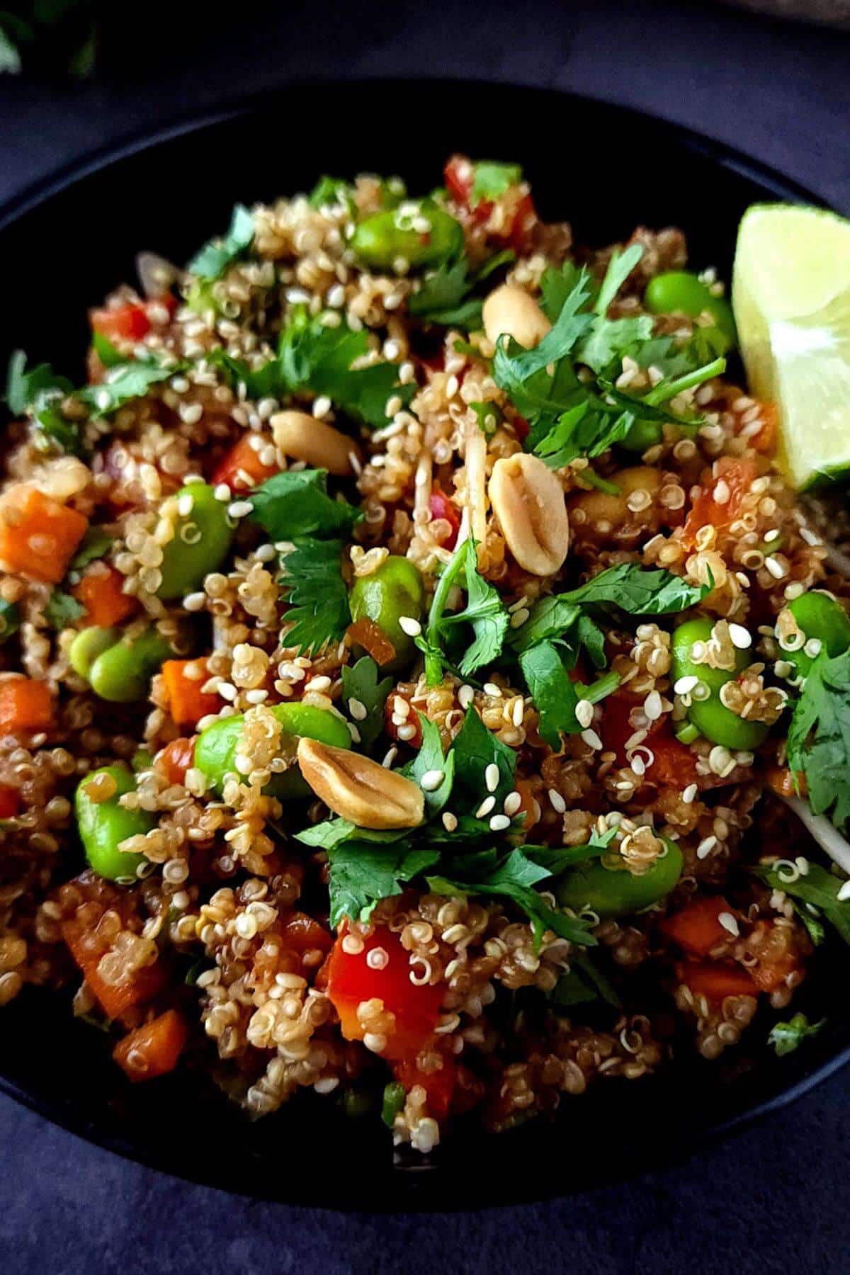 Edamame quinoa salad with fresh herbs in a bowl.