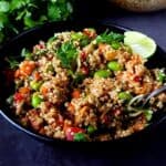 Edamame quinoa salad in a bowl with a spoon.
