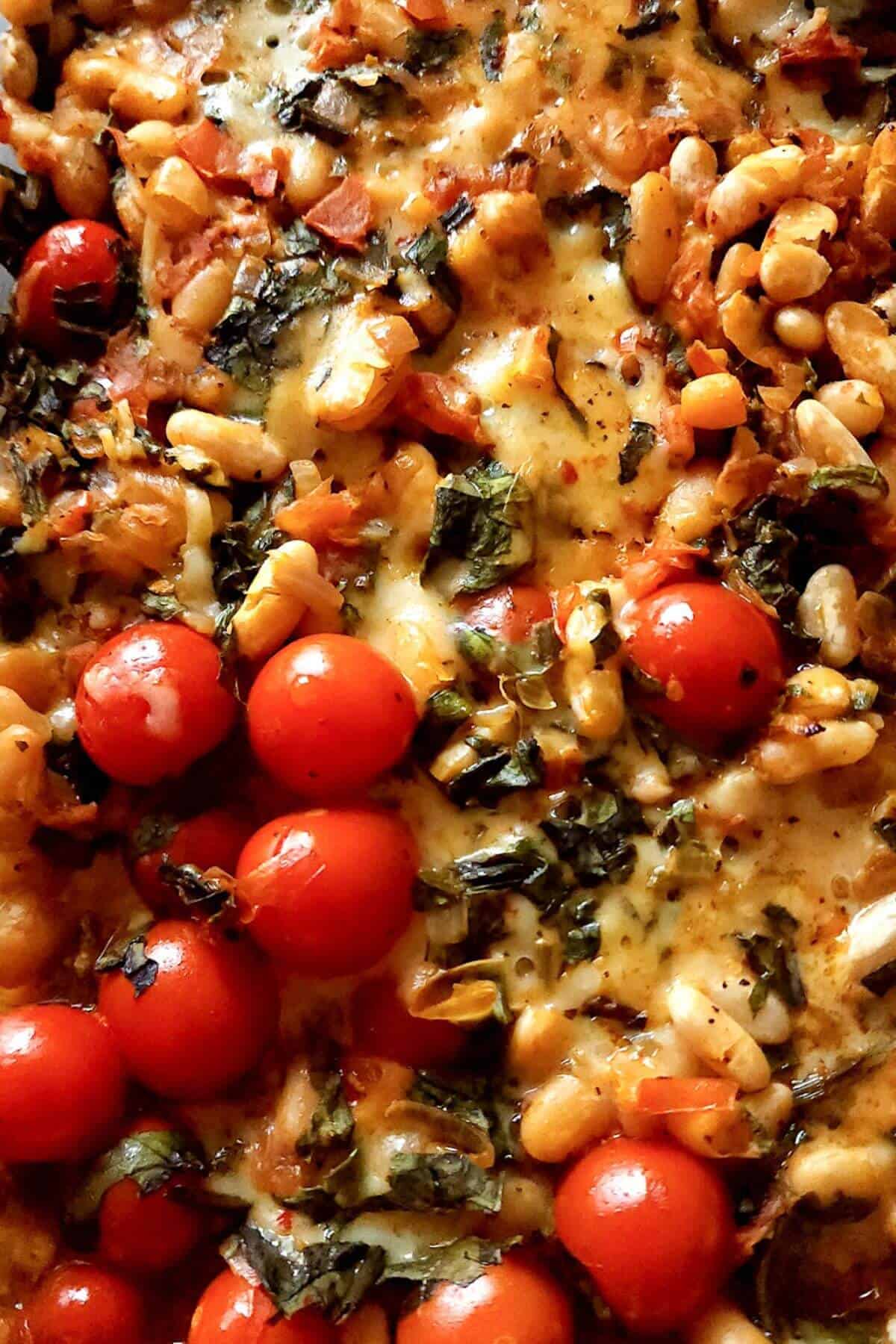 Cheesy white bean casserole with cherry tomatoes.