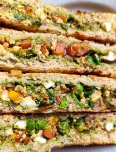 Four healthy paneer sandwiches kept on top of each other.