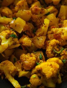 Gobhi aloo garnished with chopped cilantro.