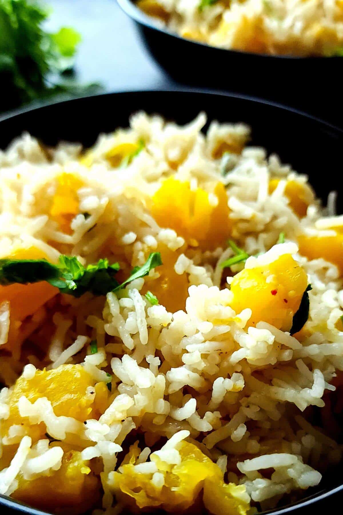 Pumpkin coconut rice garnished with chopped cilantro.
