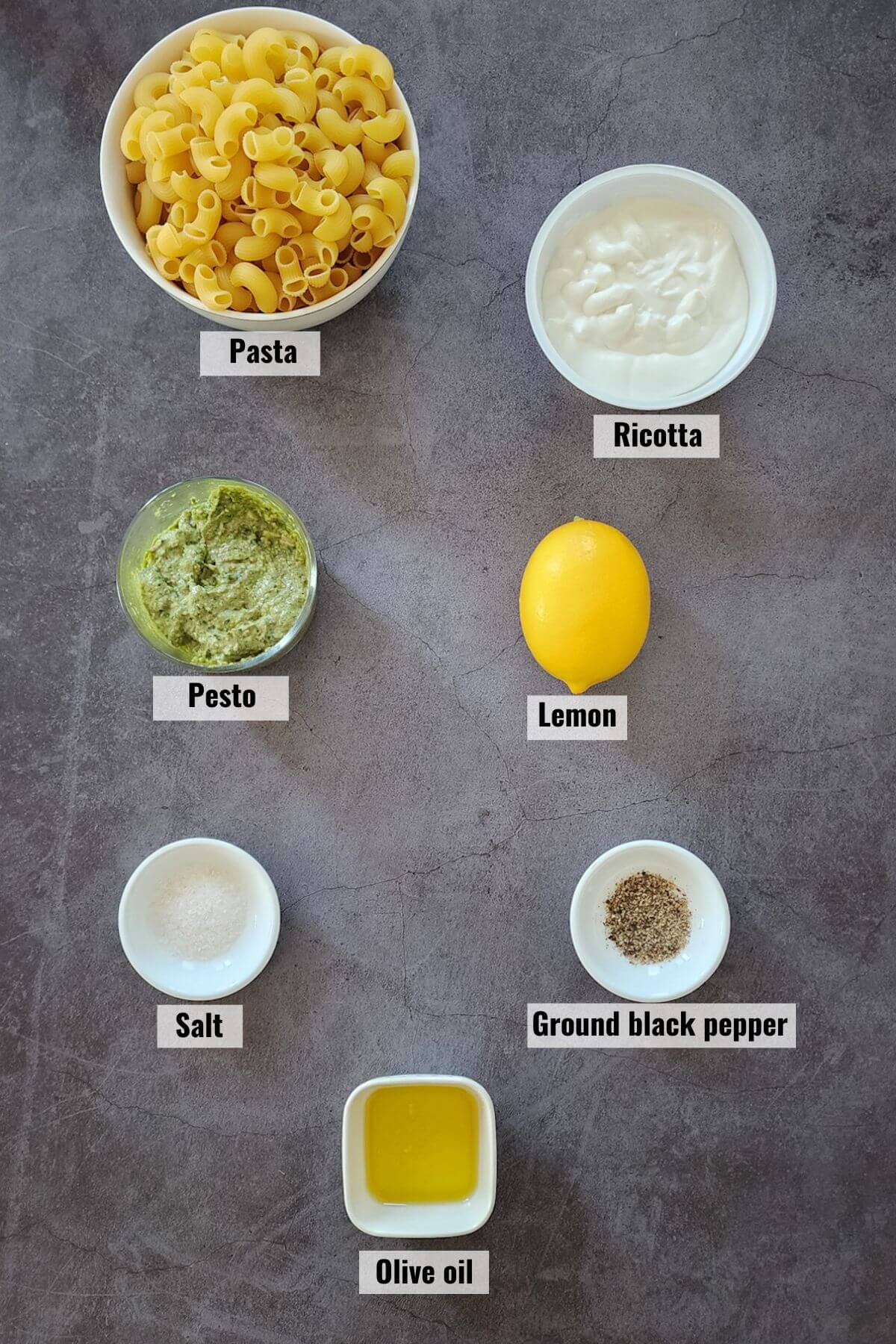 Ingredients required to make lemony ricotta cheese and pesto pasta recipe, labeled.