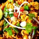 Vegan Thai red curry fried rice garnished with ben sprouts, peanuts, and cilantro.